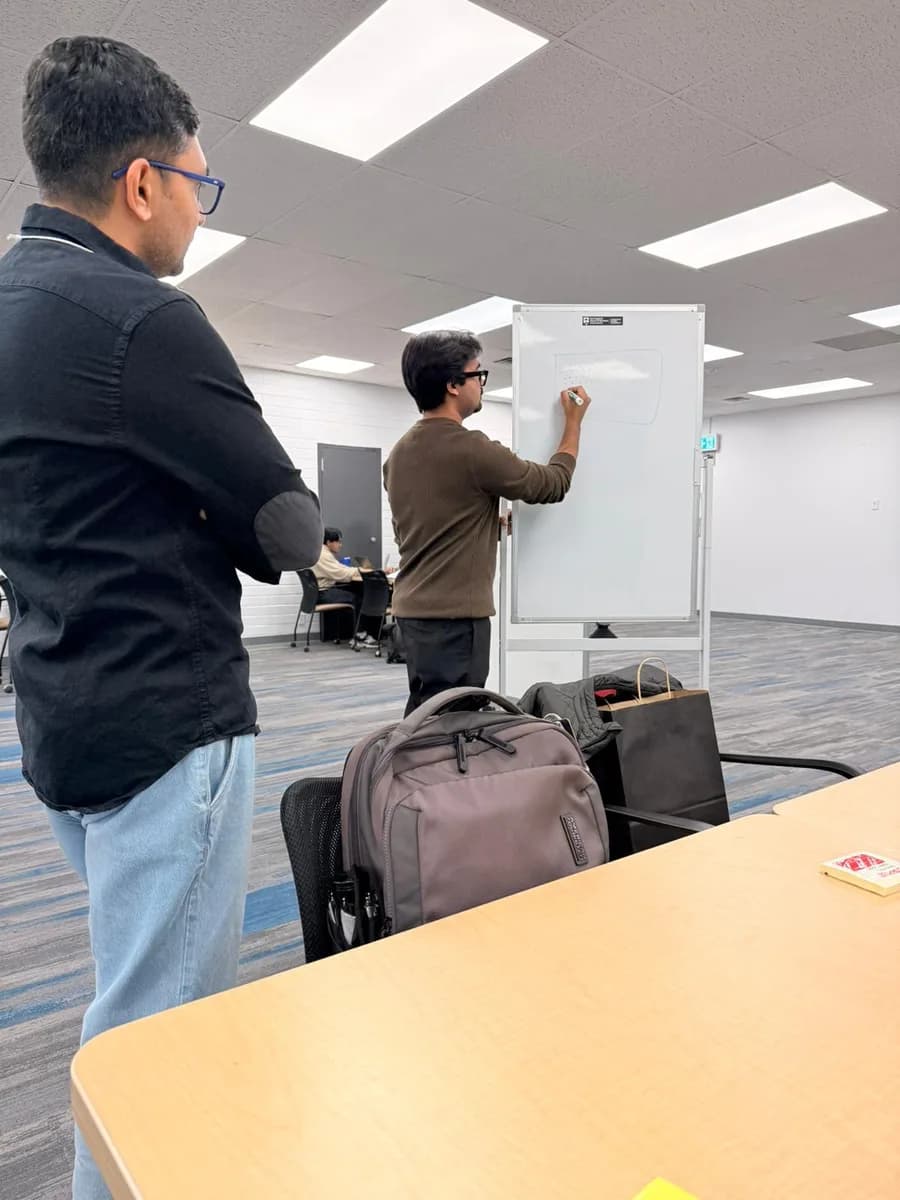 Working through the project at a whiteboard during the challenge